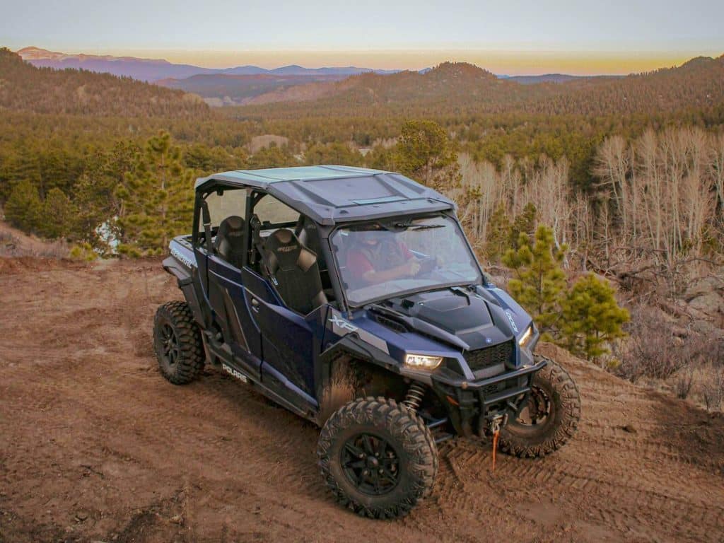 UTV driving through Pikes Peak during sunset