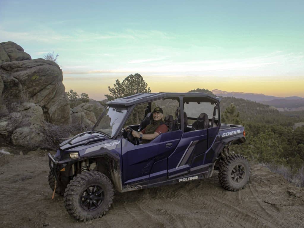 A man in a blue UTV