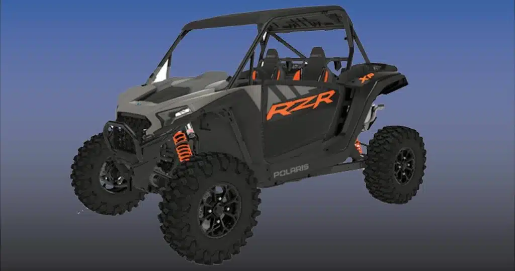 A black and orange Polaris RZR off-road vehicle against a blue background.